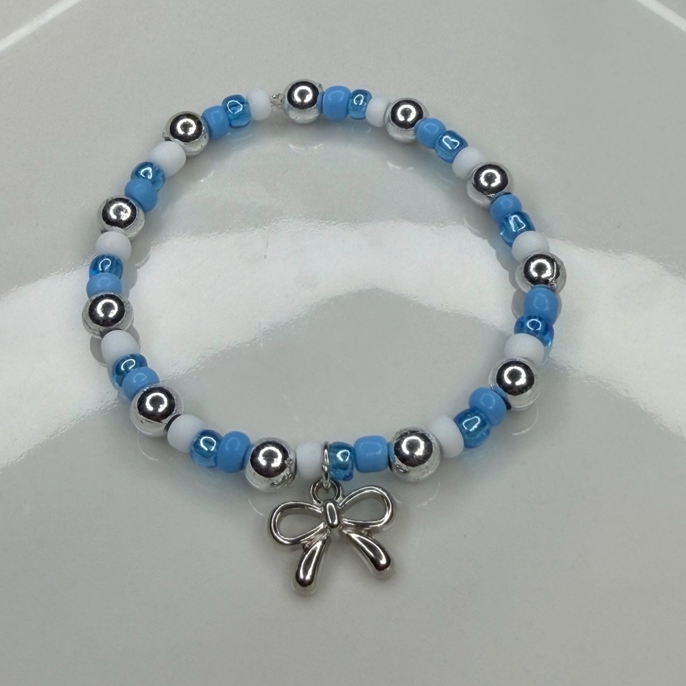 Blue and White Beaded Bracelet with Bow Charm